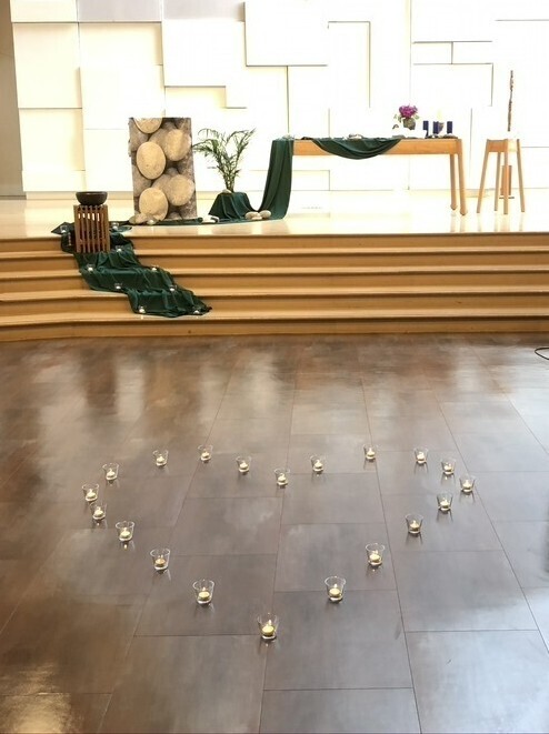 Candles in the shape of a heart on the floor of the sanctuary