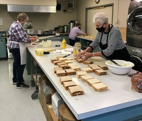 Volunteers preparing sandwiches for the Saturday Lunch program