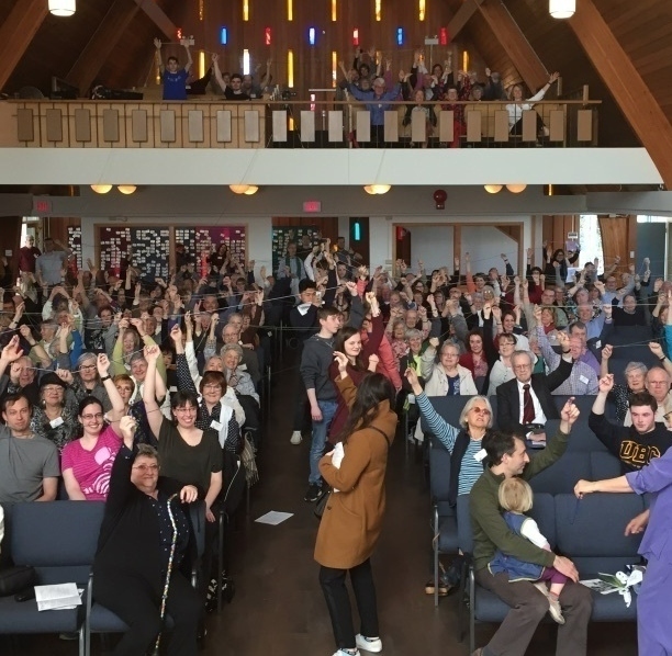 Church members holding string creating a web