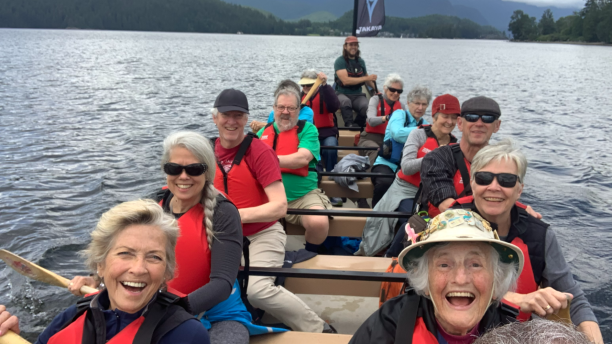 Group of people rowing in a long boat