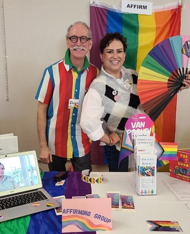 Affirm Table at Info Fair Pride Flag and People presenting information