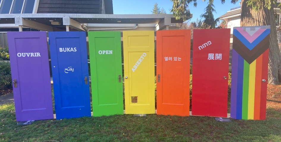 Seven Wooden doors painted in the pride colours 