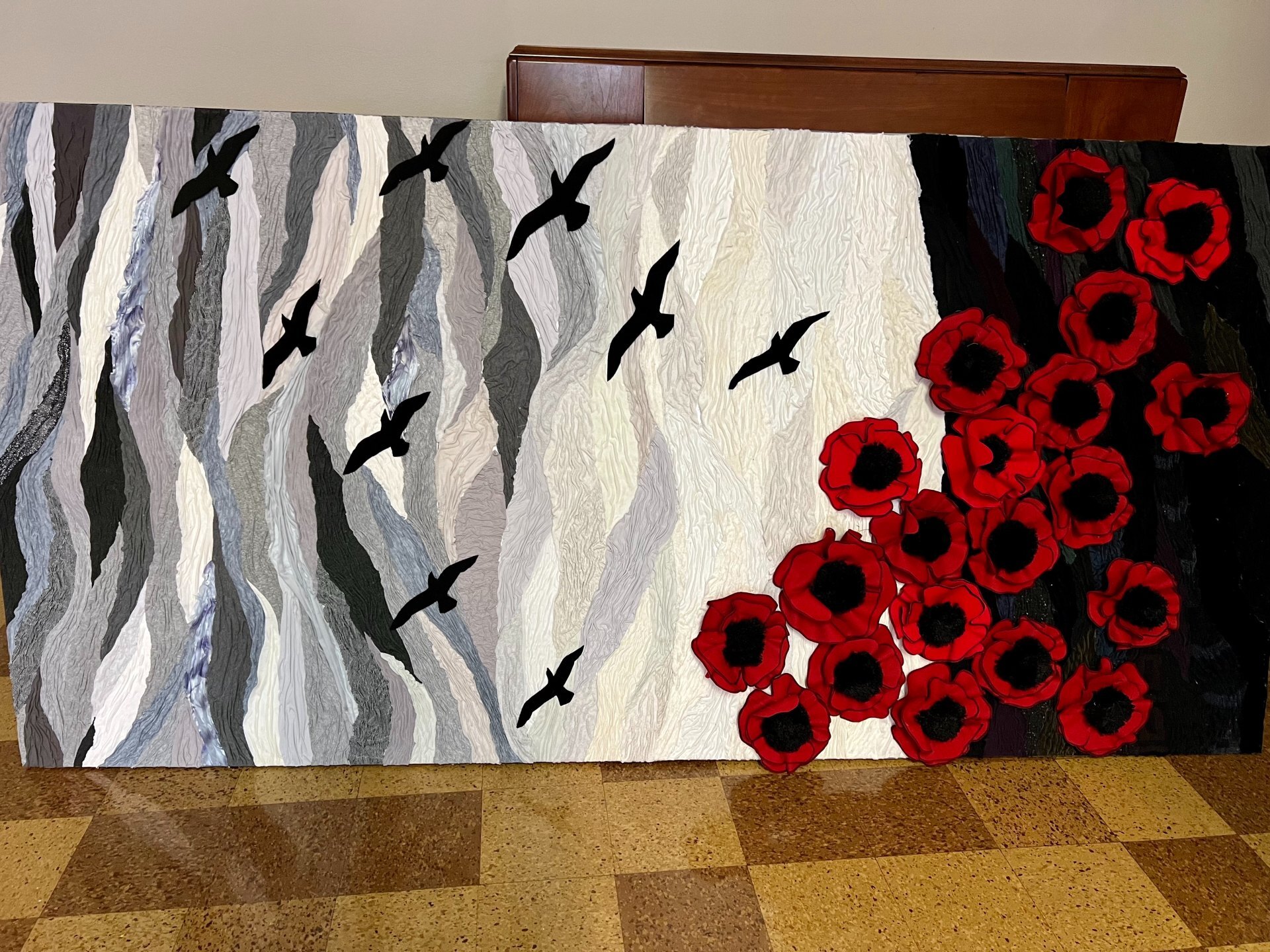 Poppy Mural, desaturated grey blue and black colours with bright red poppies